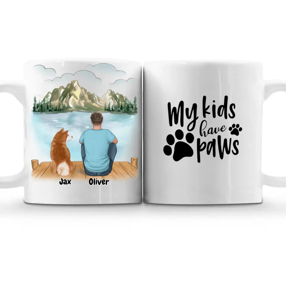 Custom pet and owner coffee mug set featuring a personalized illustration of a man and his dog sitting by a scenic lake with names "Jax" and "Oliver" below. The second mug displays the quote "My kids have paws" with paw print graphics. Perfect gift for pet lovers, dog owners, and personalized keepsakes. Dishwasher & microwave safe. Order now!