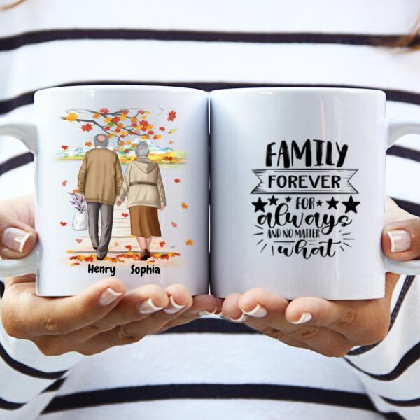 White ceramic personalized coffee mug set featuring a custom illustration of an elderly couple walking hand in hand under autumn leaves with names "Henry" and "Sophia." The second mug displays the quote "Family Forever For Always And No Matter What." A sentimental and thoughtful gift for grandparents, anniversaries, or special occasions. Dishwasher and microwave safe. Order now!